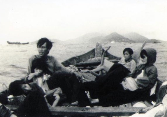 Quynh leans against her dad with her sister (left), her mom and newborn sister (directly across) as they fled Vietnam in 1979.