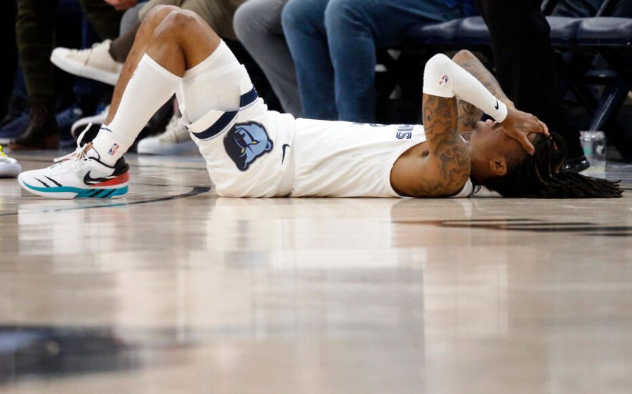 Feb 25, 2023; Memphis, Tennessee, USA; Memphis Grizzlies guard Ja Morant (12) lays on the court during the first half against the Denver Nuggets at FedExForum. Mandatory Credit: Petre Thomas-USA TODAY Sports/Sipa USA - Photo by Icon sport